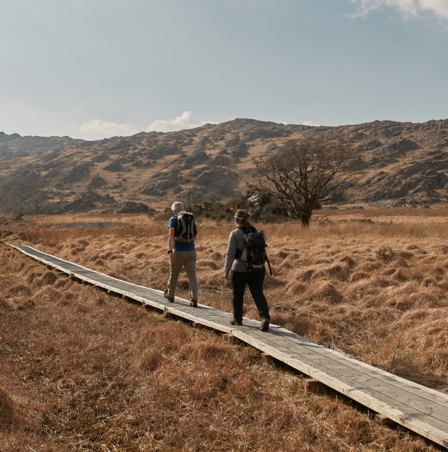 Two visitors walking along boardwalk