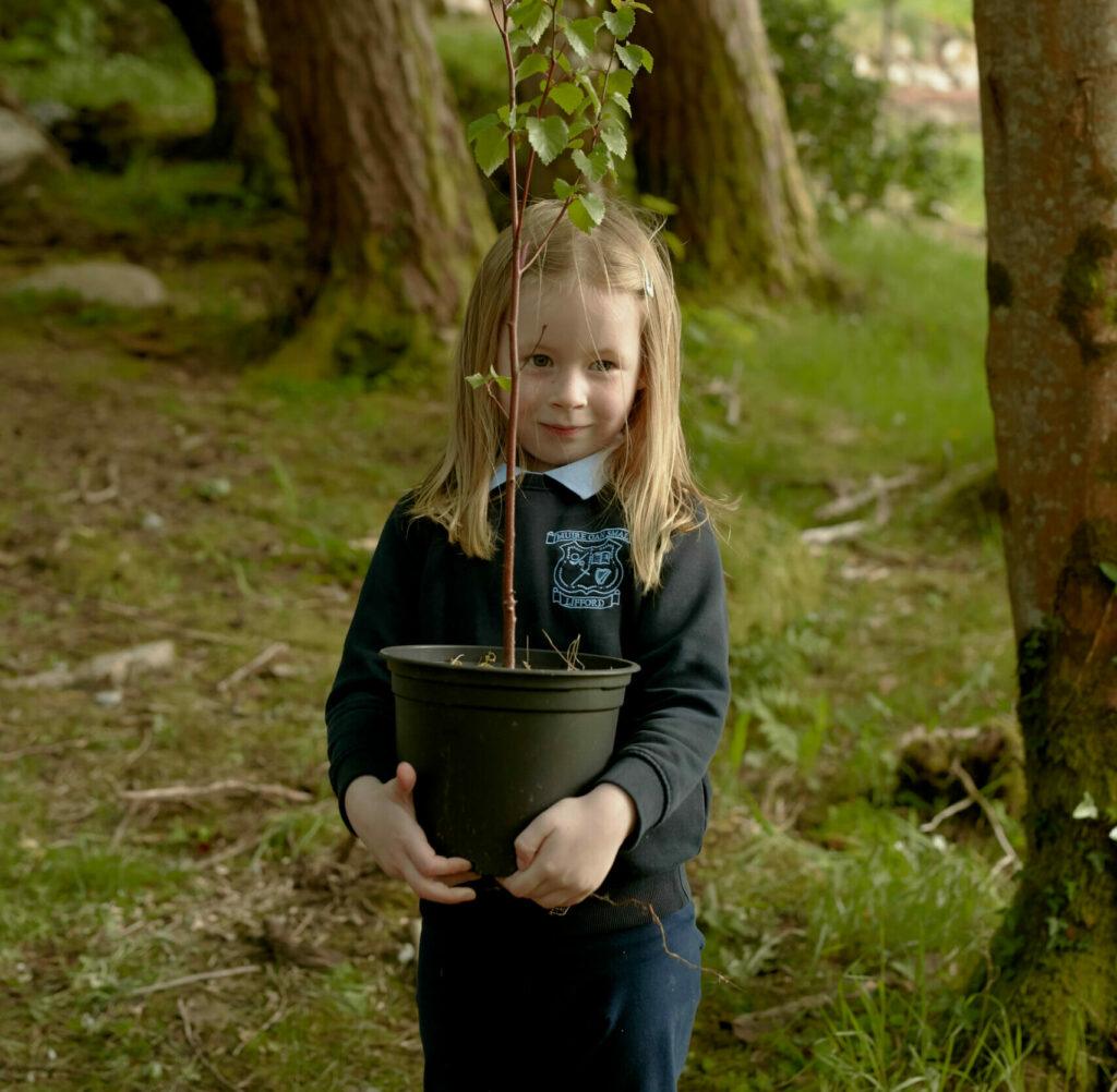 Girl holding plant