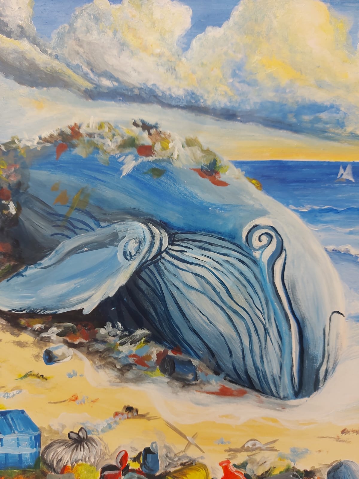 Whale image on beach with litter